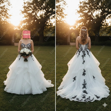 Load image into Gallery viewer, Black Lace Appliques White Tulle Ball Gown Wedding Dress Spaghetti Straps Corset Back Tiered Bridal Gown for Outdoor Garden Wedding W22.1
